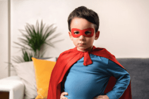 Litte boy wearing super hero outfit